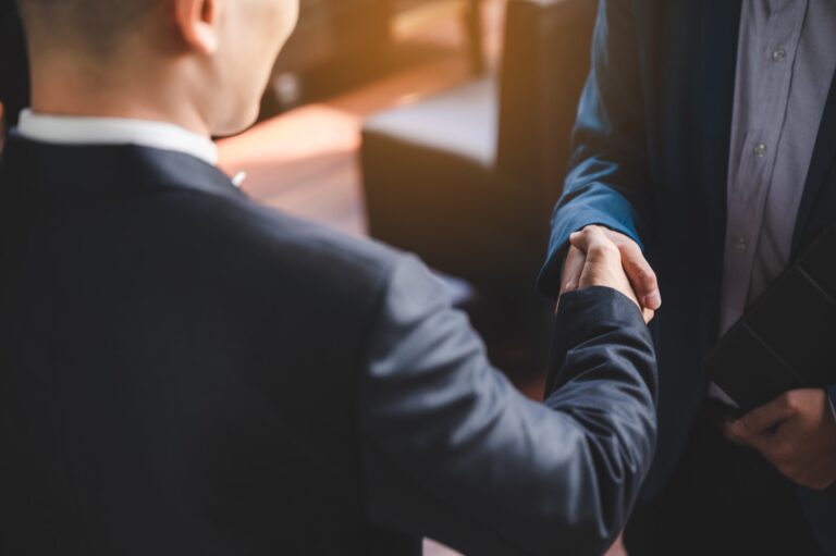 Business owner shaking hands after a debt settlement agreement