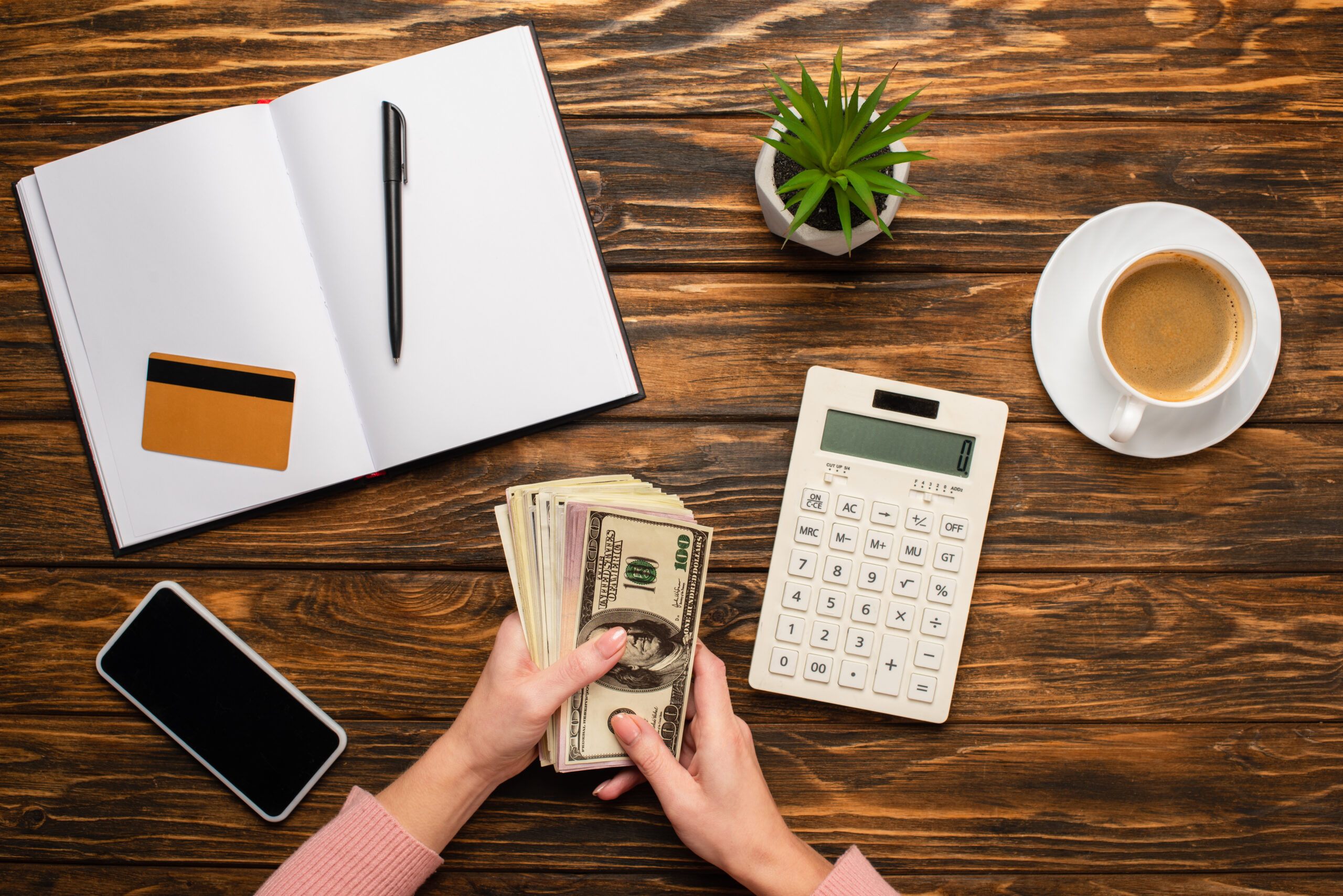 Business owner counting cash to cover merchant cash advance payments