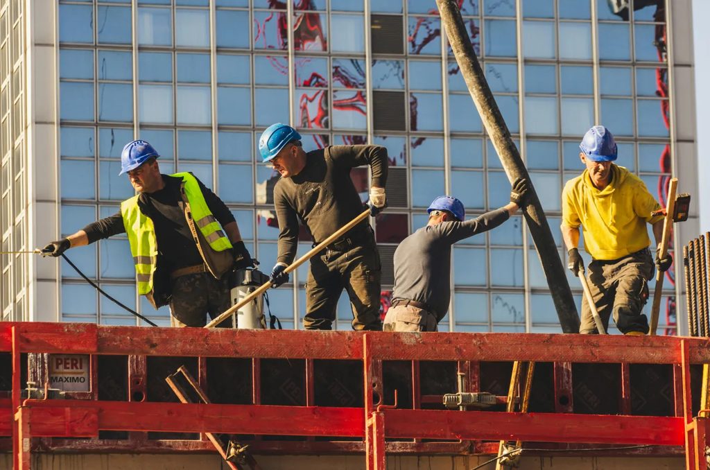 Construction crew pouring concrete on a building site